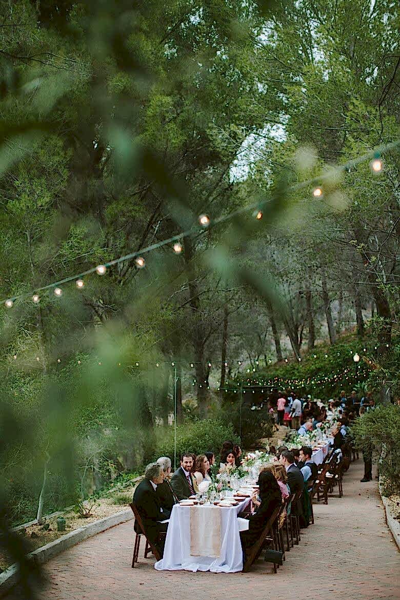 Family sitting at a long table eating together