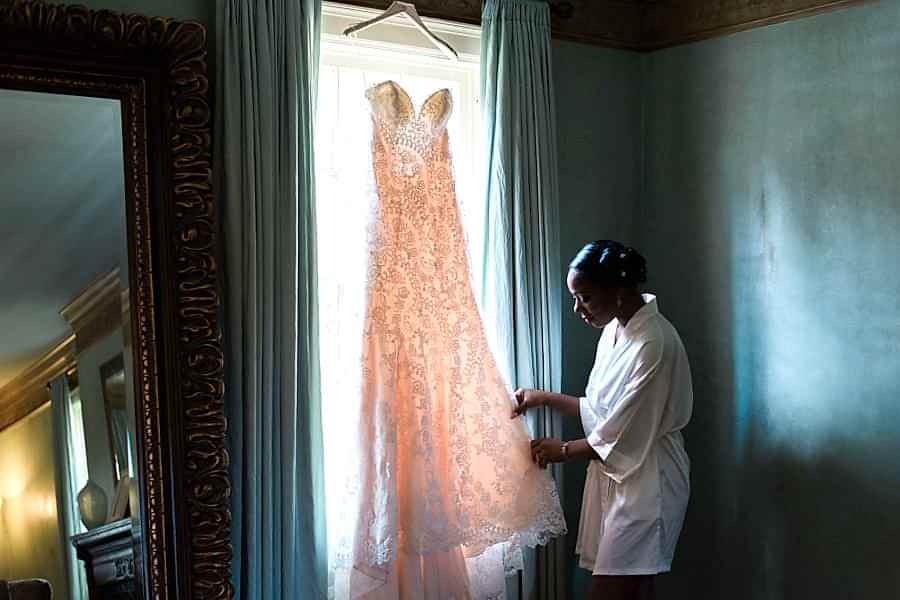 wedding vendor tips - Bride looking at her wedding dress in a window