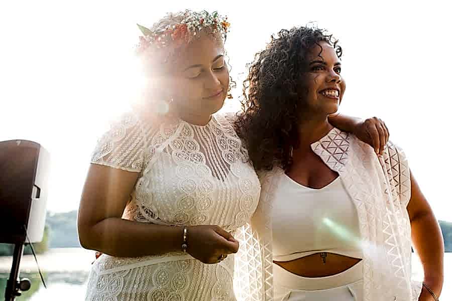Two brides hugging