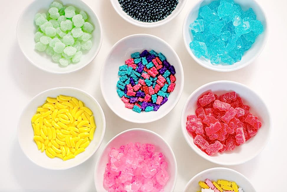 crate and barrel pinch bowls filled with several different kinds of colorful candies