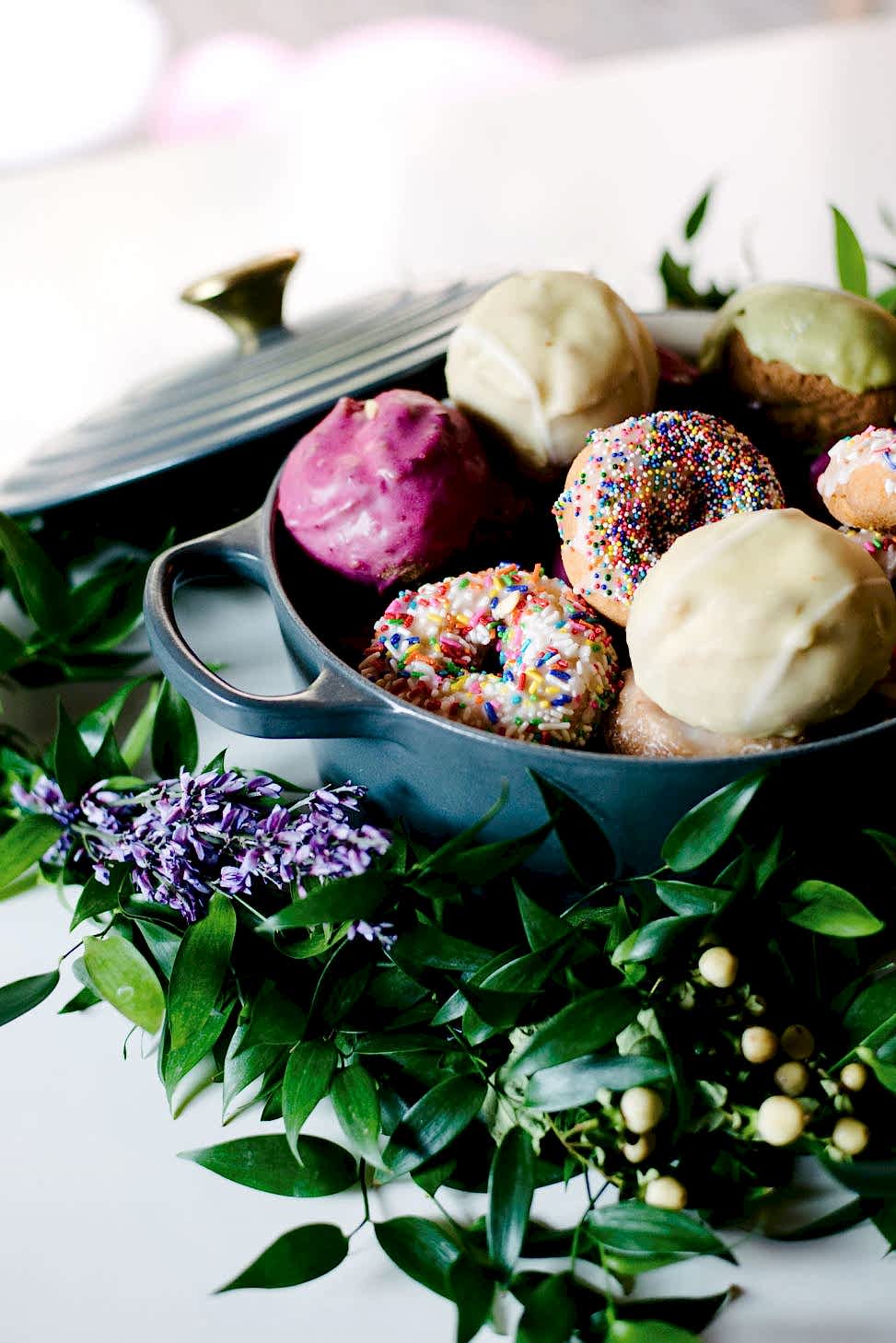 graphite grey le creuset filled with vegan donuts and donuts with rainbow sprinkles