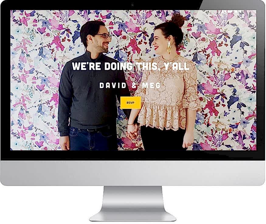 Man and woman standing in front of colorful abstract floral wall, holding hands, looking at each other as background image for screen that reads "We're doing this, y'all - David & Meg - RSVP"