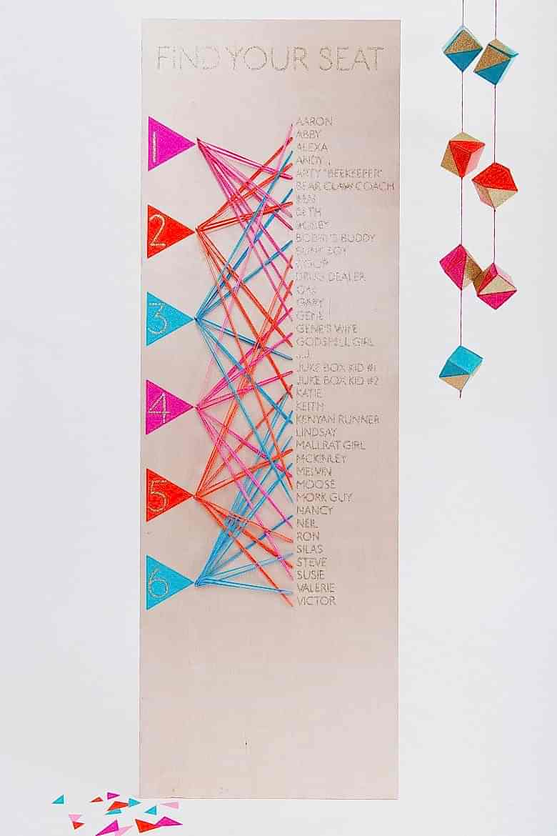 diy wedding seating chart made from plywood and neon rubber bands
