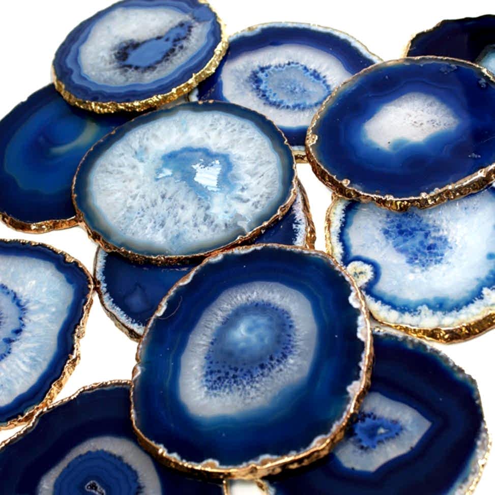 Pile of blue agate coasters on white