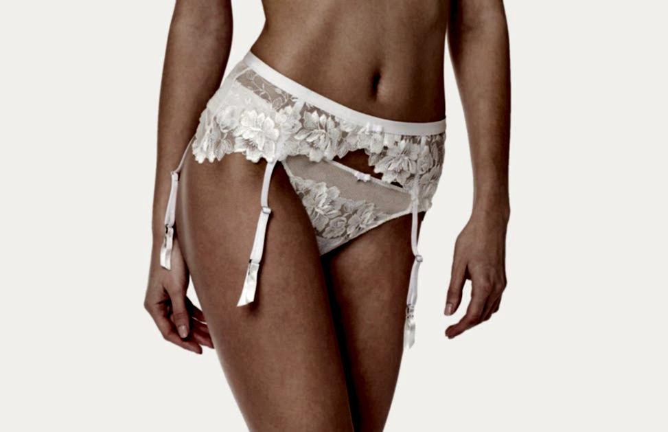Close up of woman wearing white floral waist garter and underwear