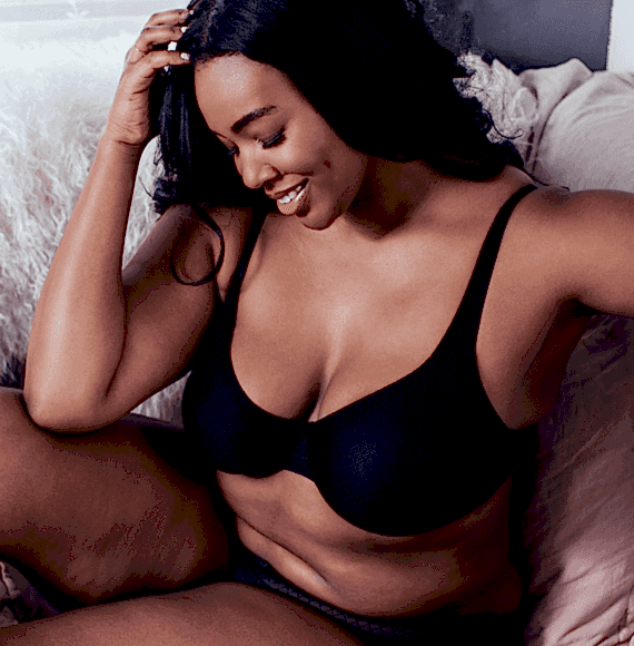 Brunette woman in underwear set sitting