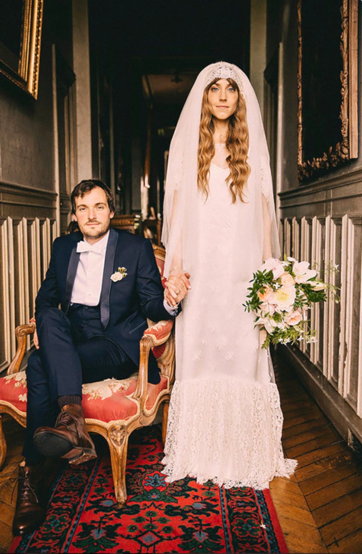 wedding themes - bride wearing an antique veil holding sitting husbands hand