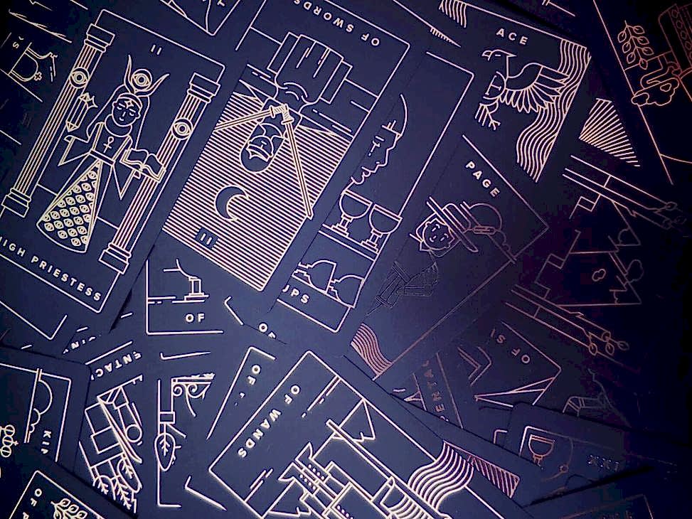 Pile of black and gold tarot cards