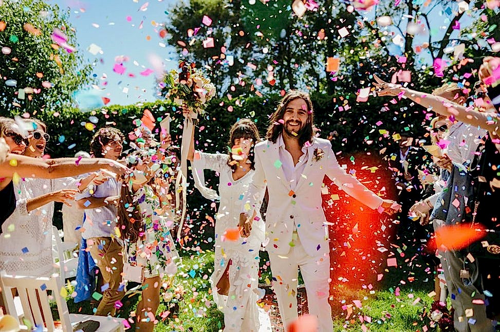 couple walking through confetti