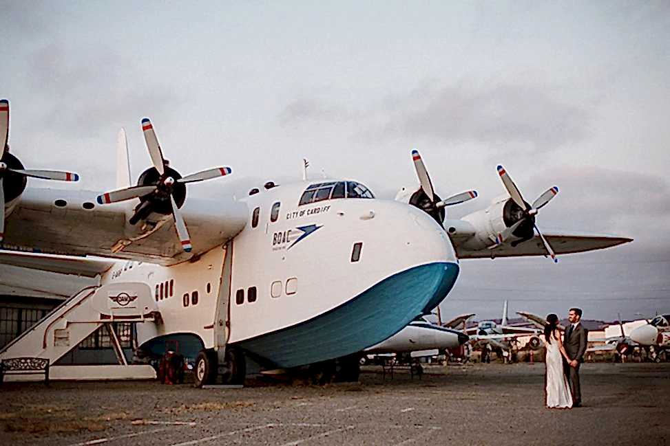 couple standing by an airplane