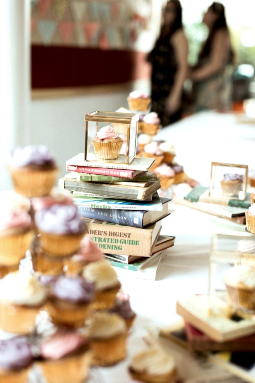 book centerpiece with a cupcake on top 