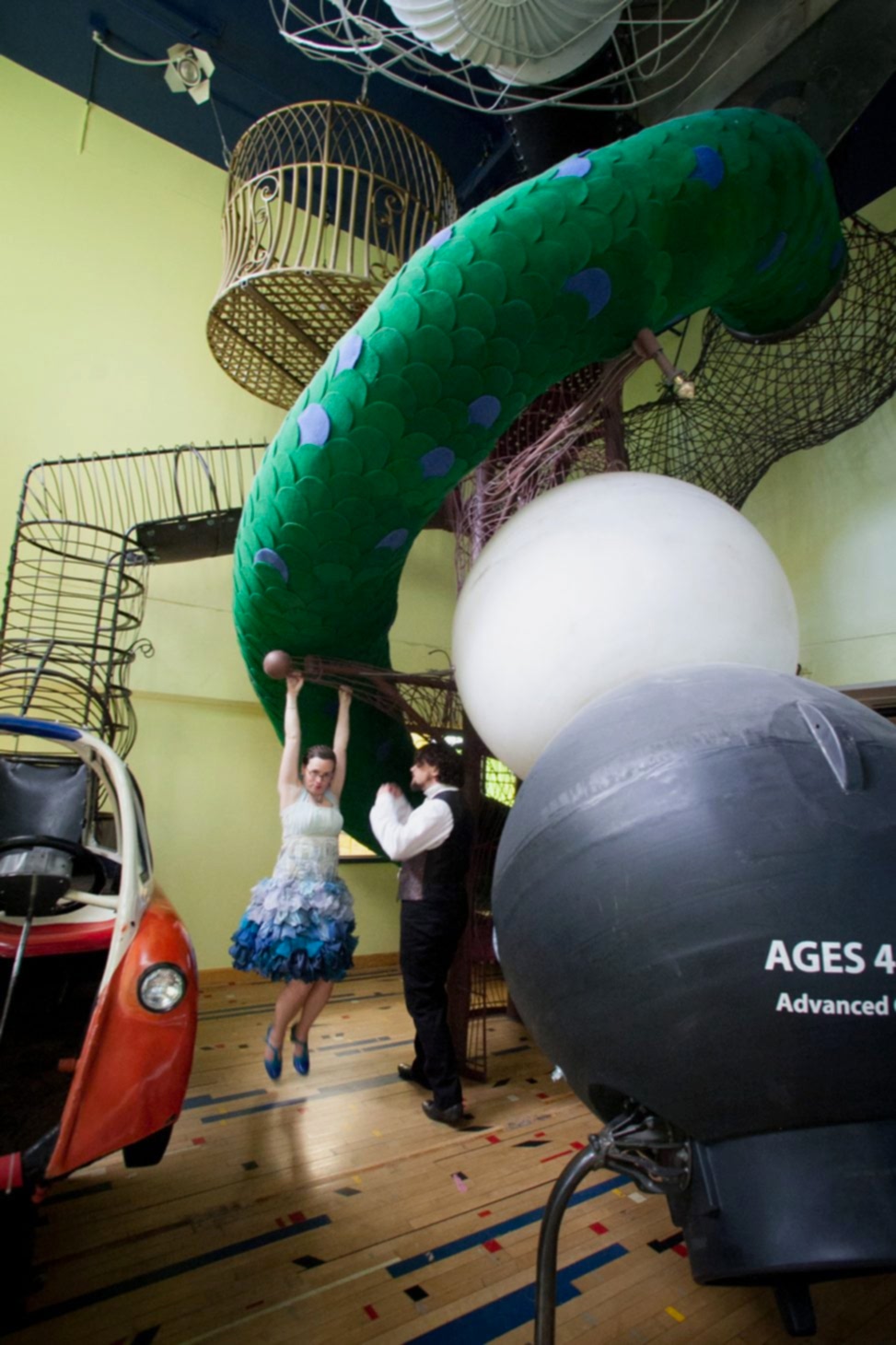 bride and groom playing on children's museum installation