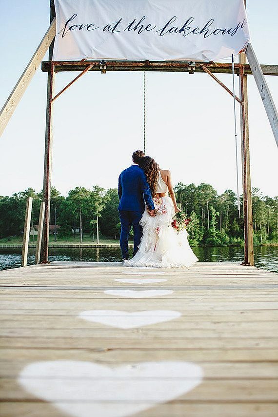 a couple stand together on a deck