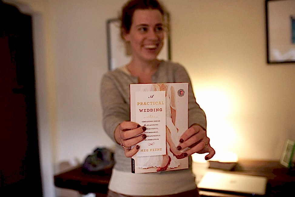 Meg Keene holding A Practical Wedding
