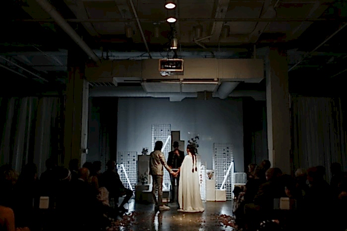 couple getting married in front of an art instillation