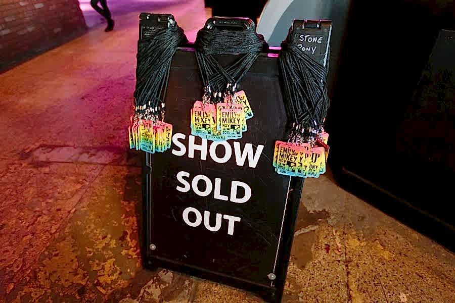 concert passes on a concert "sold out" sign