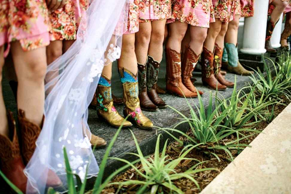 row of women in colorful cowboy boots