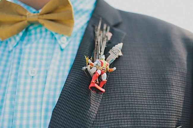 man wearing a boutonniere with a small superhero figurine attached to it
