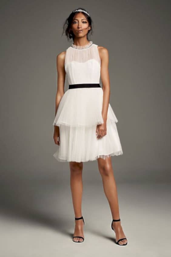 A short wedding dress with a black belt sash