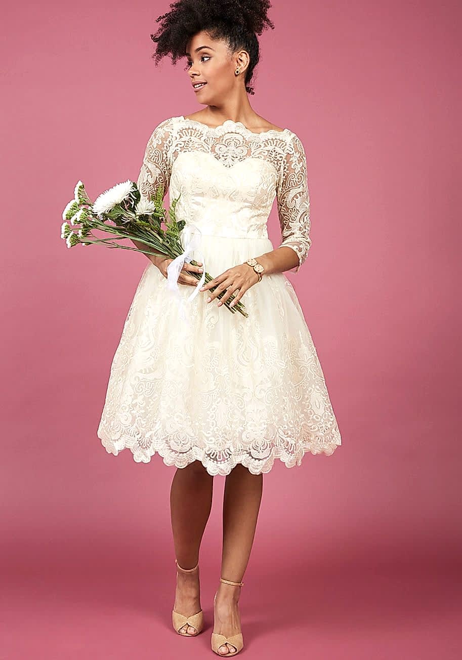black woman with lace white dress and flowers