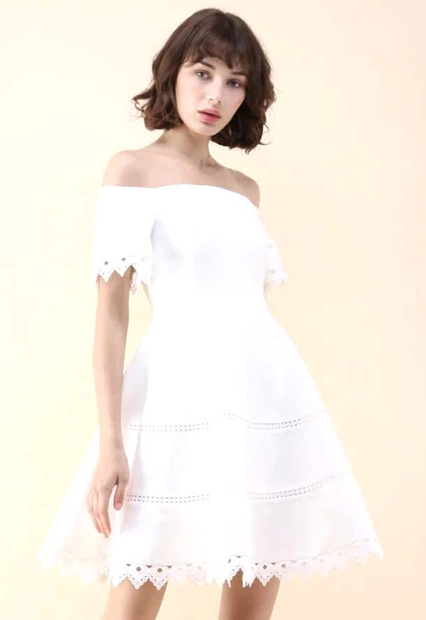 woman wearing a dress with a Bardot neckline, fit-and-flare silhouette, and lace hemline