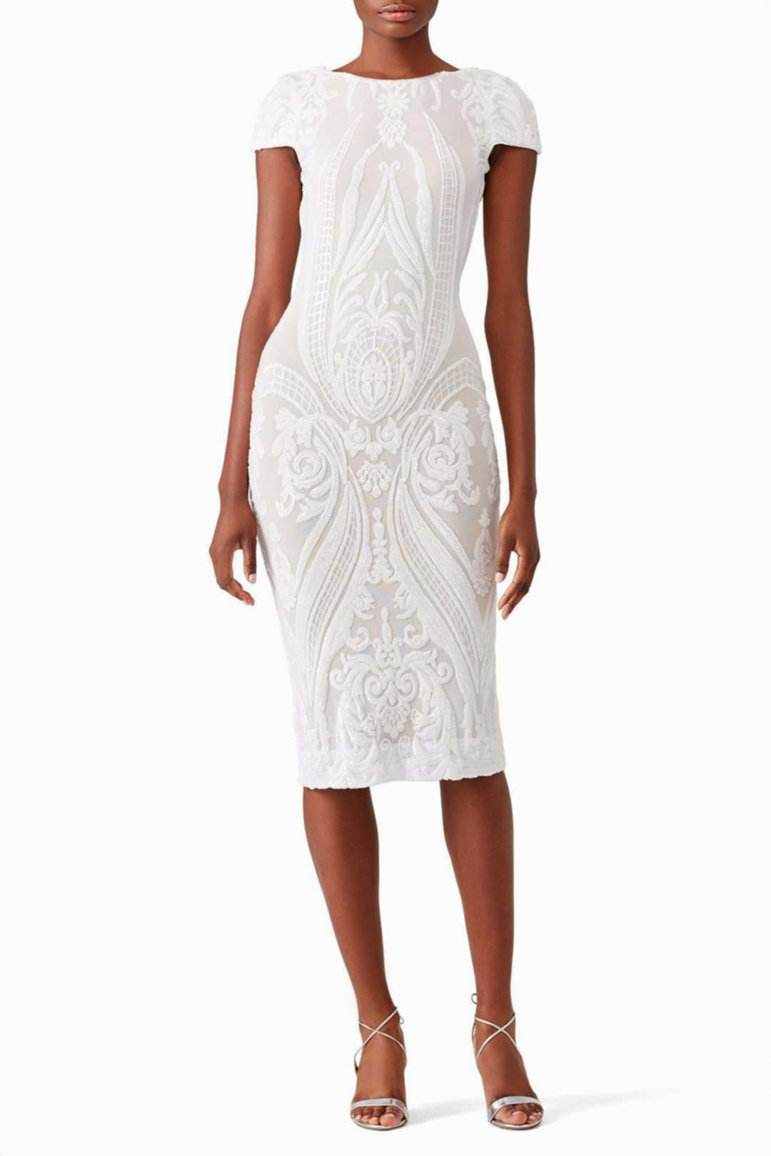 black woman wearing a white dress with intricate embellishments