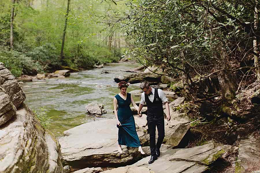 Couple getting married by a waterfall