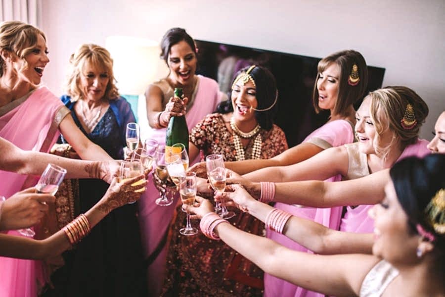 Bridal Shower Games - a bride and her party hold their glasses together.