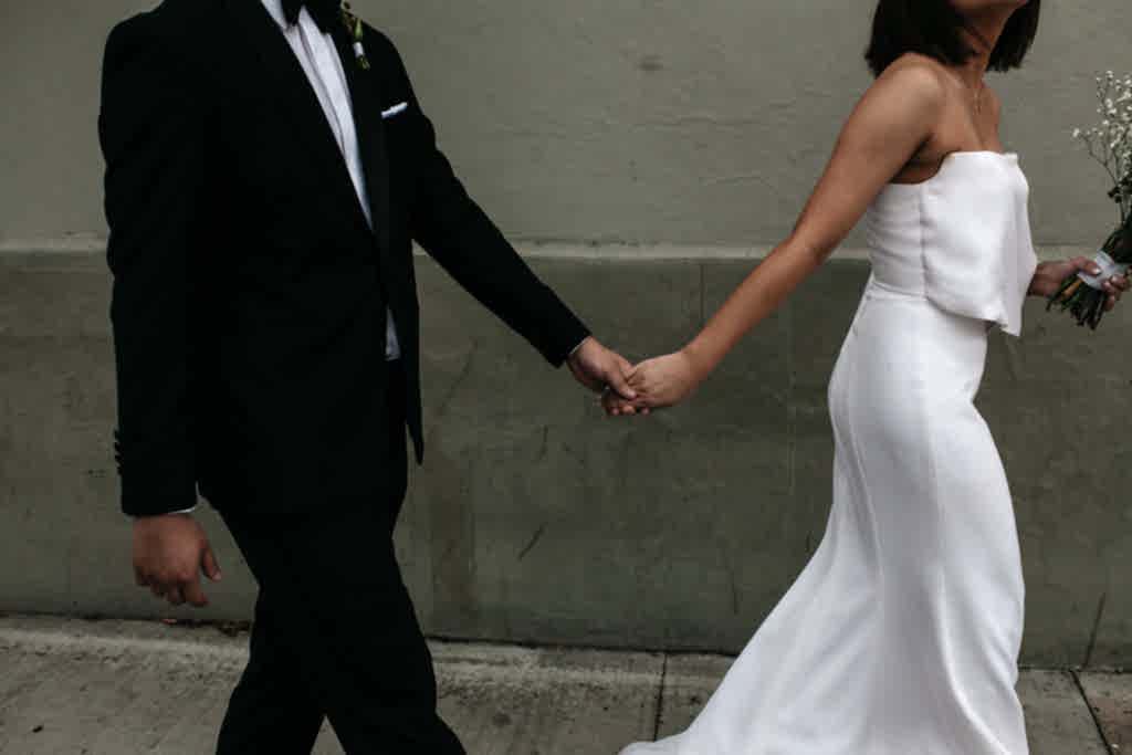 Wedding couple holding hands