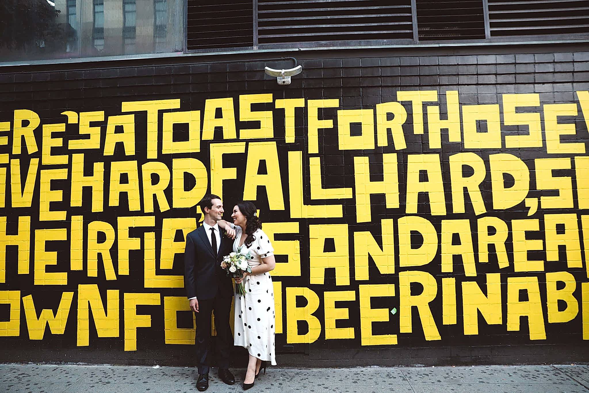 Wedding couple in front of a mural