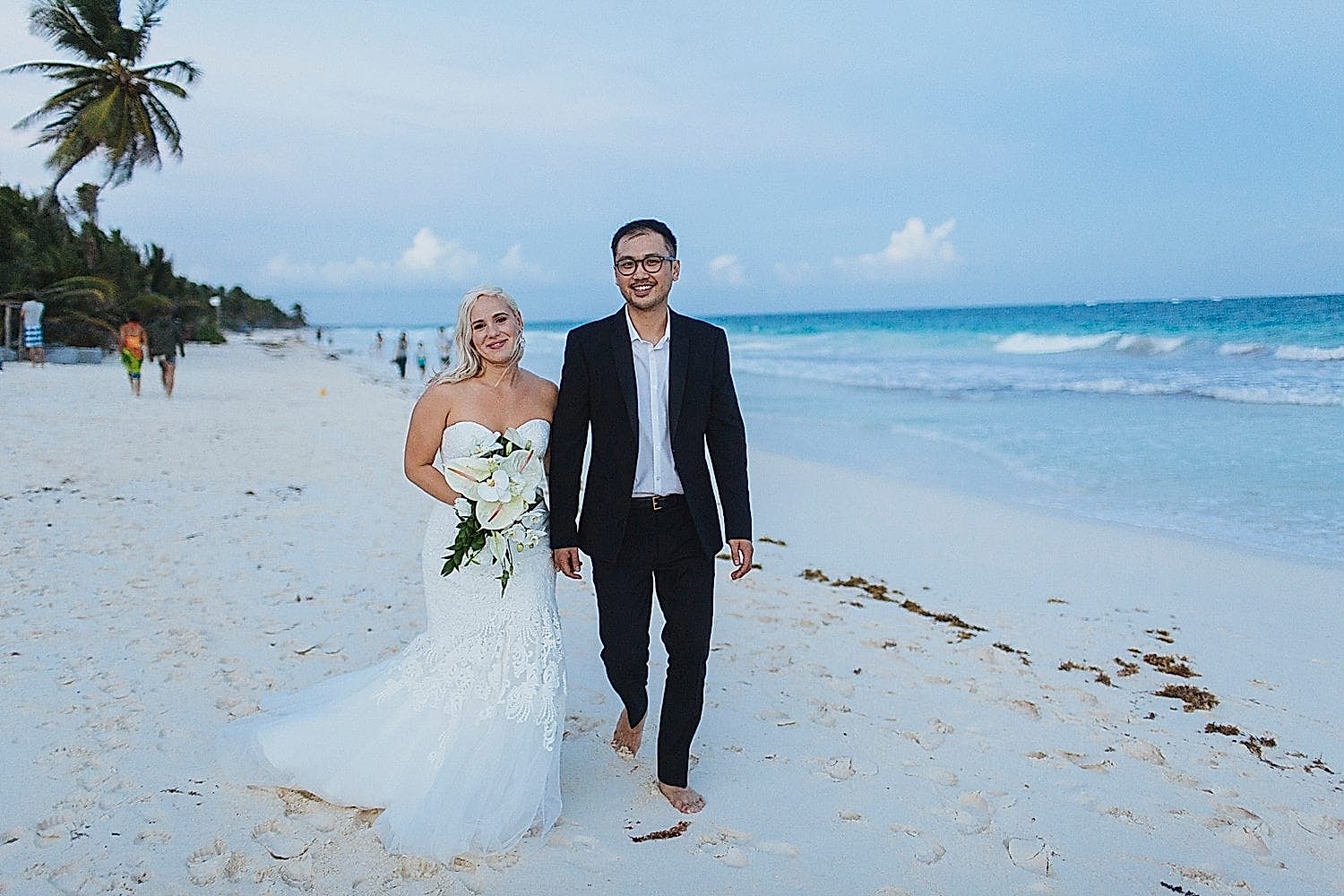 A man and woman walk together, at the beach