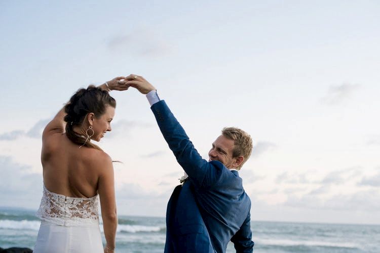 A man and woman dance at the beach