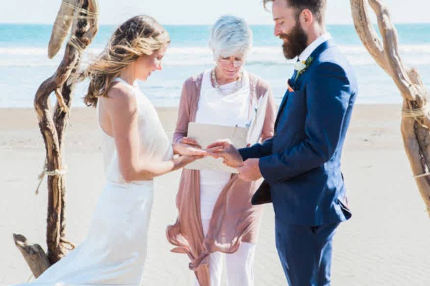 Beach wedding under a driftwood arch