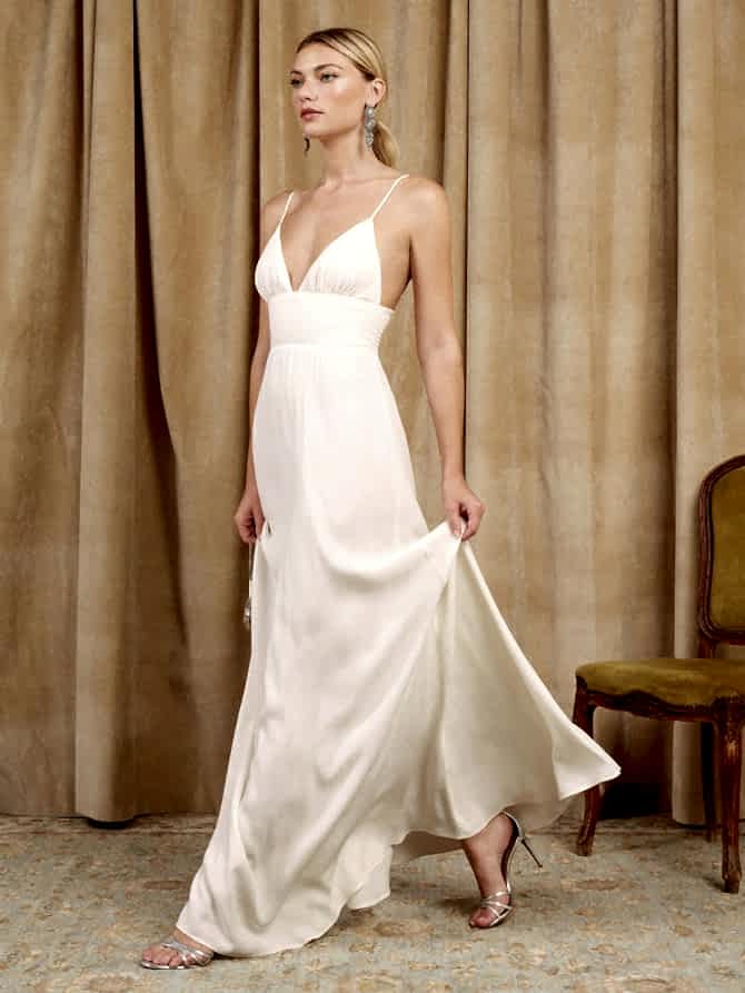 A woman wears a triangle bodice white dress with spaghetti straps