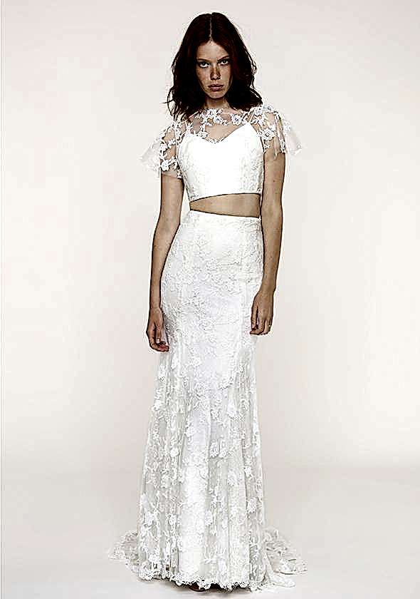 A woman wears a white two-piece dress with bare upper midriff and lace overlay