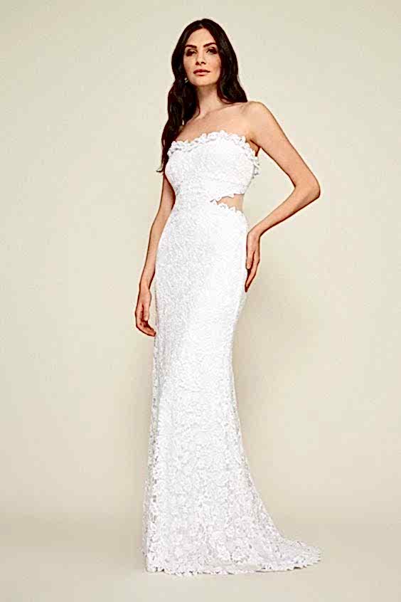 A woman wears a strapless lace white dress with peek-a-boo cutout sides
