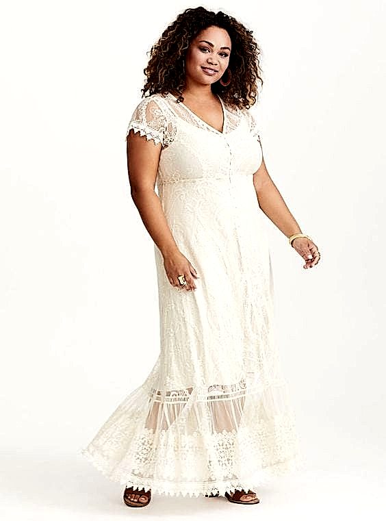 A woman wears a short spaghetti strap under dress covered with a sheer and lace short-sleeved, button-down full-length overlay