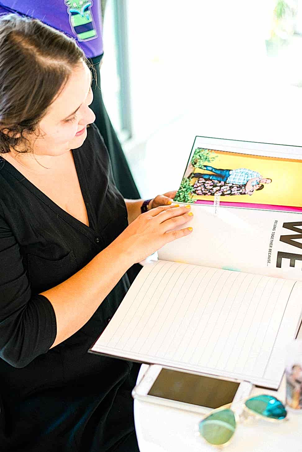 a woman looks through a custom printed guest book