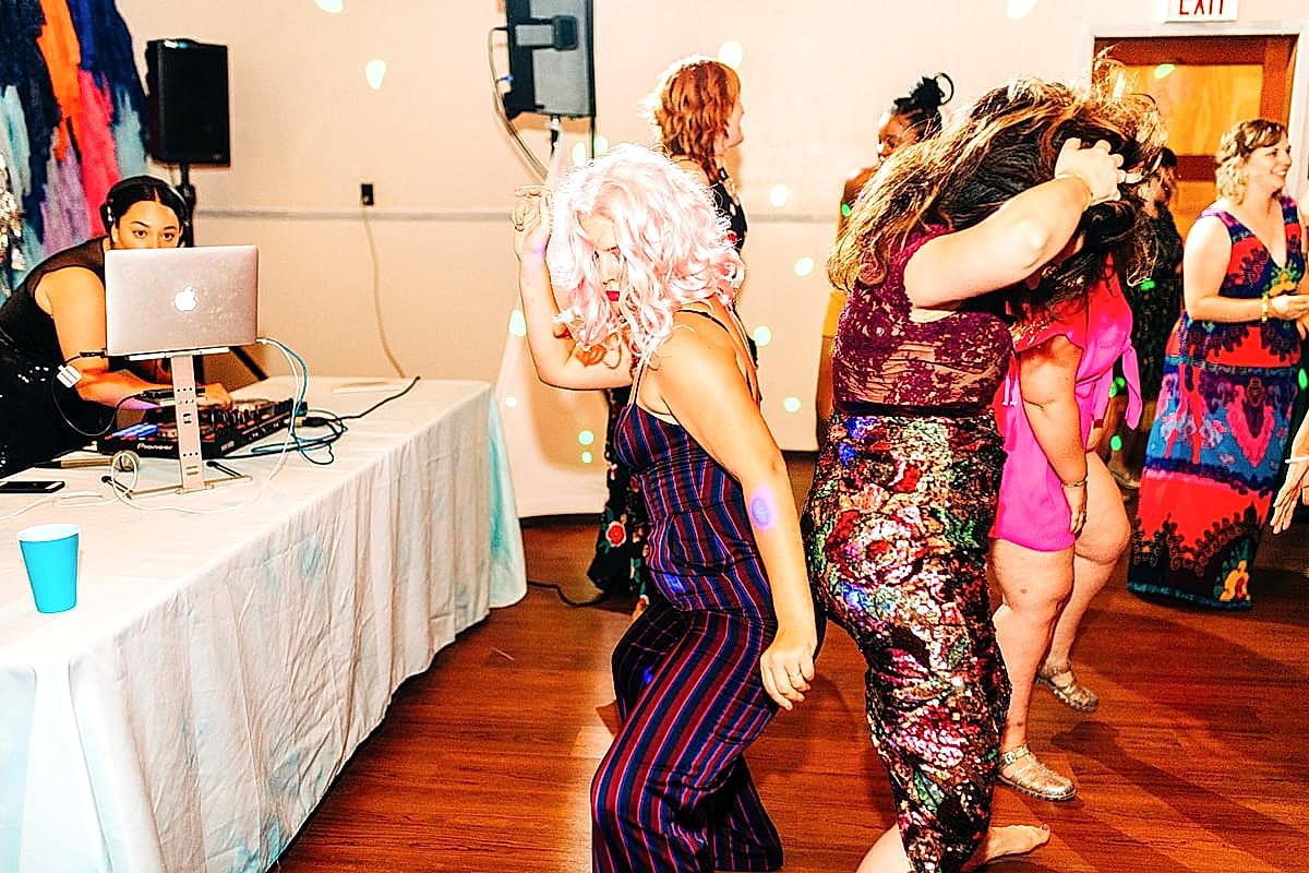 Women getting down on the dance floor as DJ Lady Q drops beats at the compact summer camp in la Honda, CA