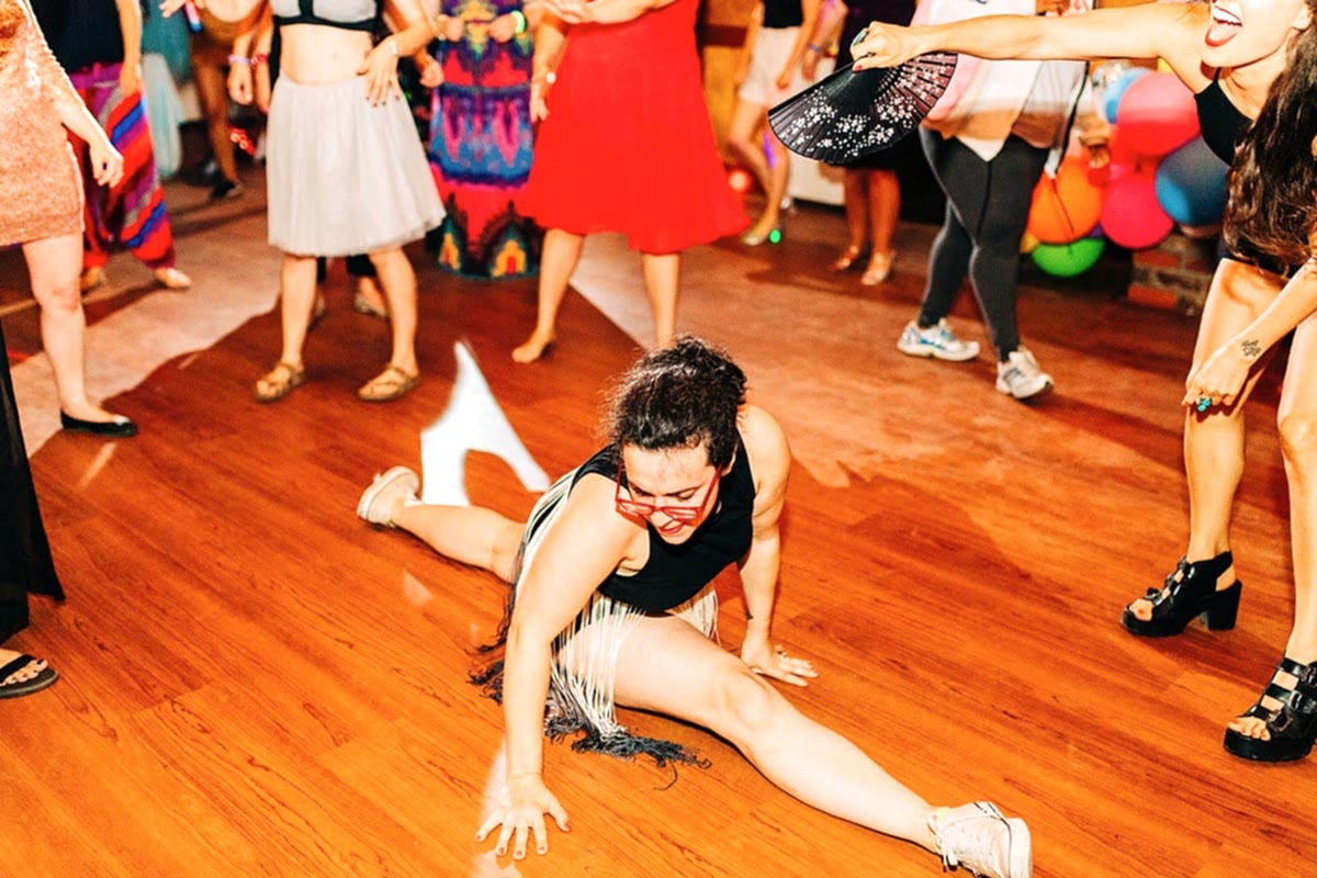 Women getting down on the dance floor as DJ Lady Q drops beats at the compact summer camp in la Honda, CA