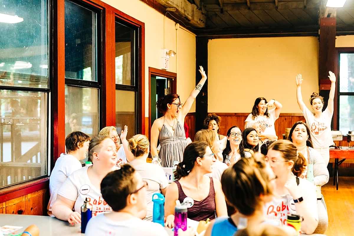 Women jumping up as they win bingo at the compact summer camp in la Honda, CA