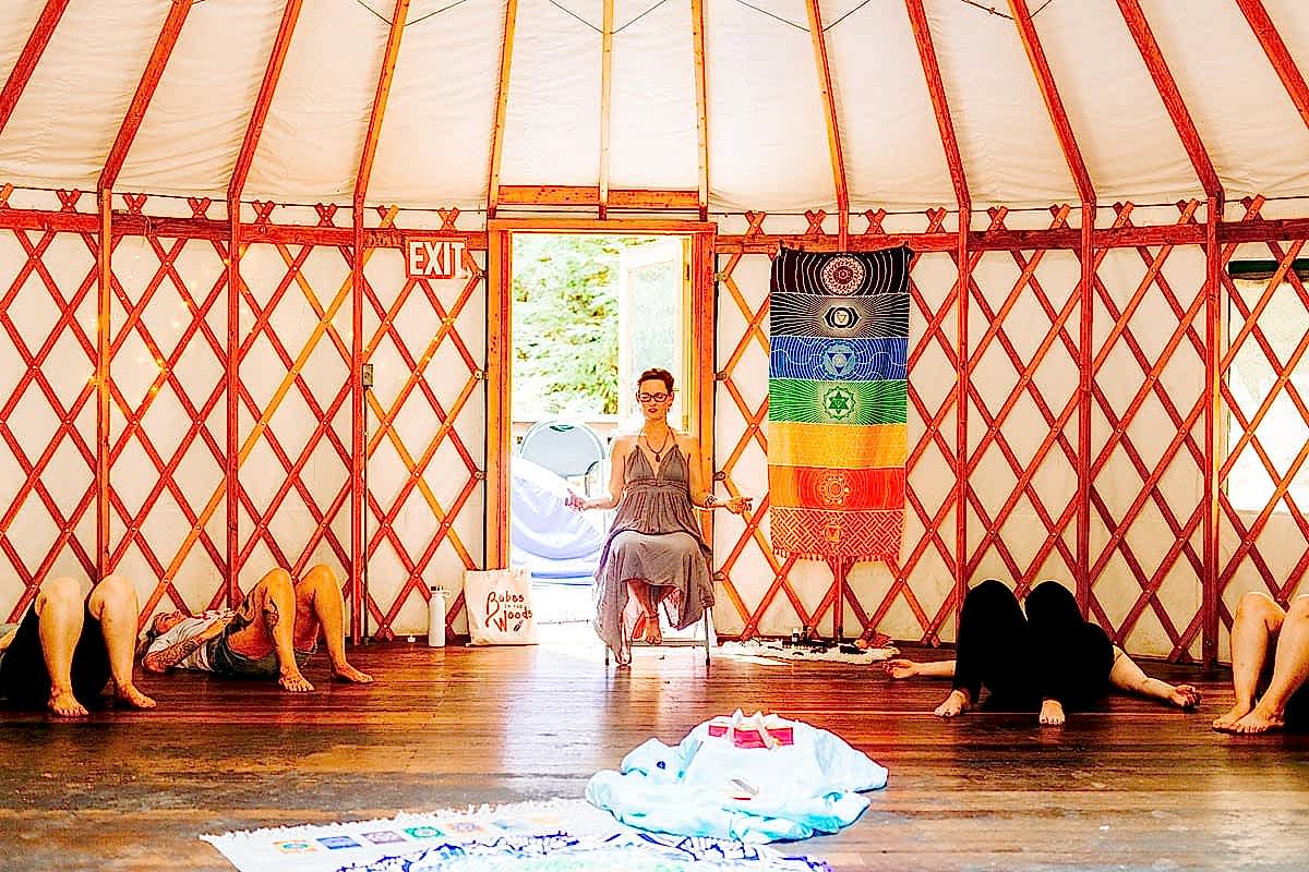 Women meditating in the yurt during Leah Tioxon's Chakra Alignment workshop at the compact summer camp in la Honda, CA