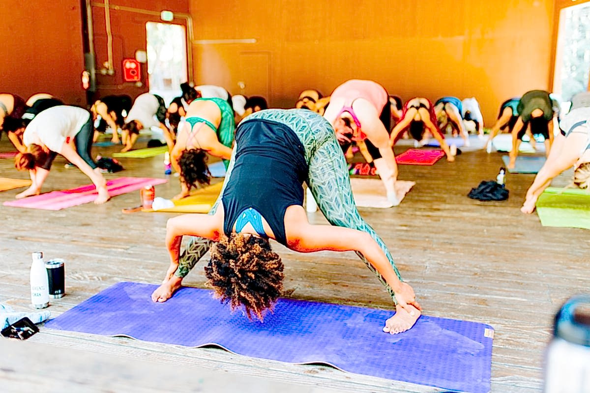 Women doing yoga during Chloe Jackman's workshop at the compact summer camp in la Honda, CA