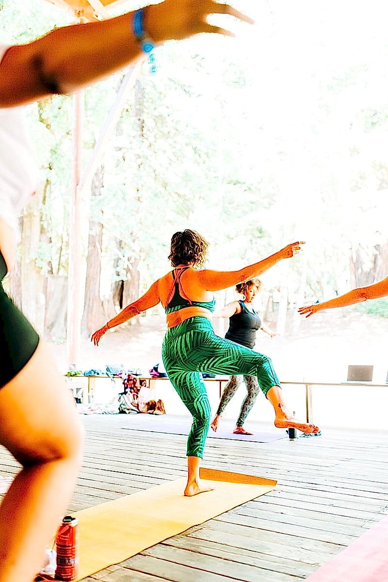 Women doing yoga during Chloe Jackman's workshop at the compact summer camp in la Honda, CA