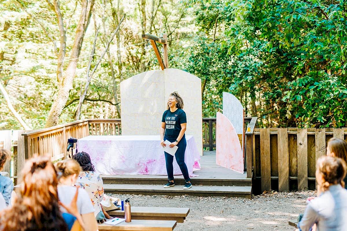 Monique Malcom stands on stage leading her workshop at the compact summer camp in la Honda, CA