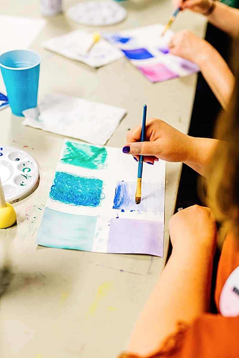 A close up of a hand practicing watercolor techniques at the compact summer camp in la Honda, CA