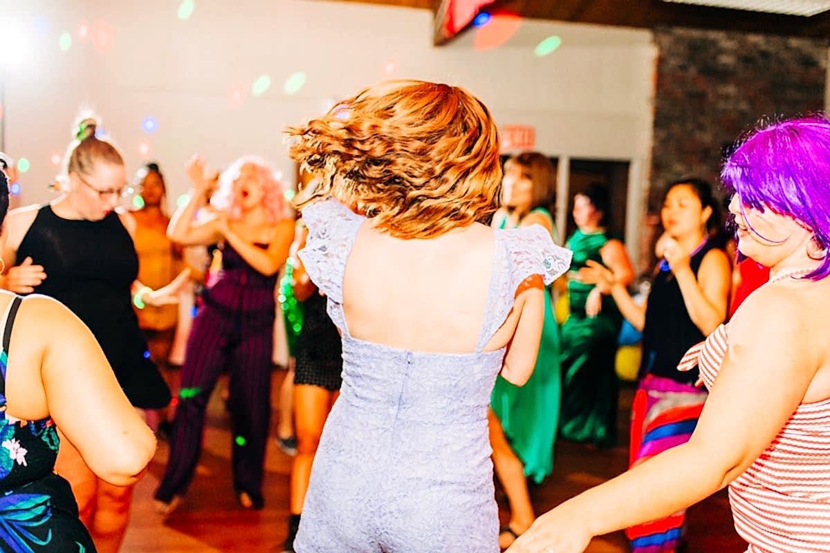Women in party clothes shaking it off on the dance floor