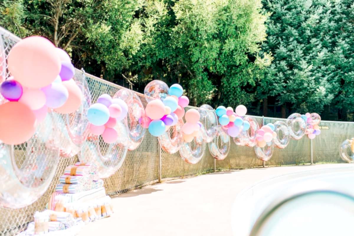 a sparkly pool floaty and colorful ballon installation at the compact summer camp in la Honda, CA