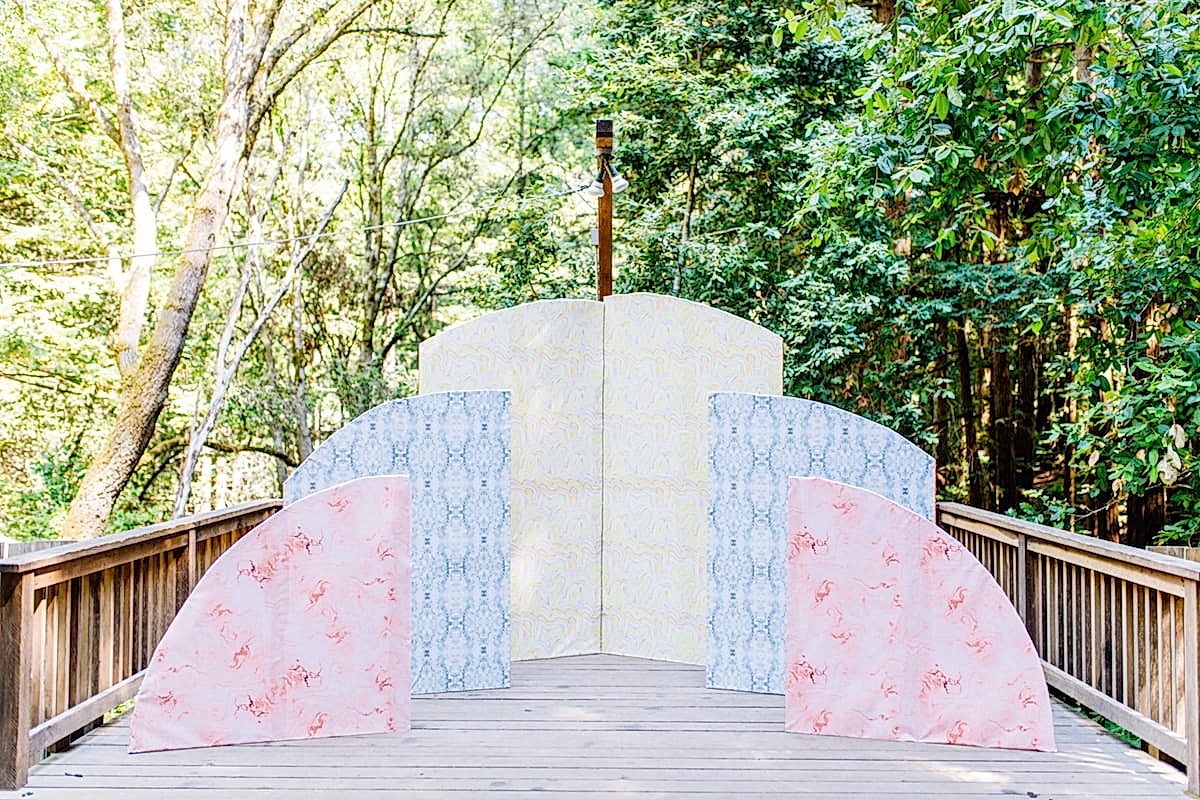 A sunset-inspired large paper installation on a wood deck at the compact summer camp in la Honda, CA