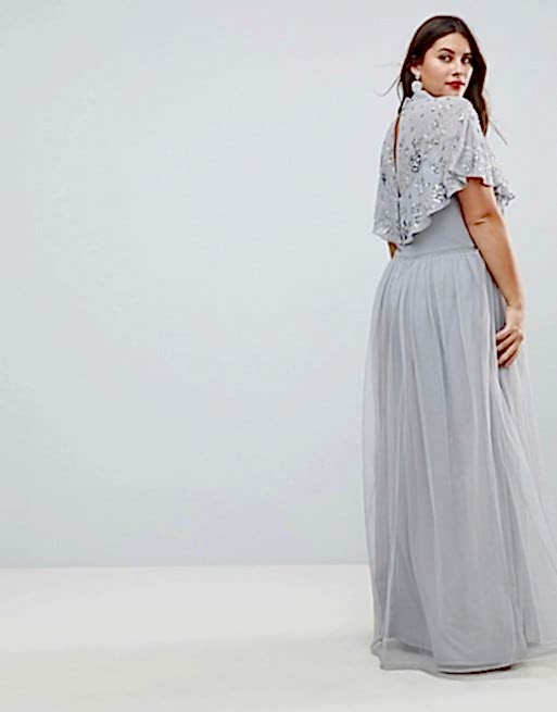 Brunette looking over shoulder while wearing grey gown
